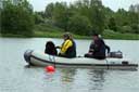 picture of brown newfoundland dog and owner sat in boat prior to start of exercise 1